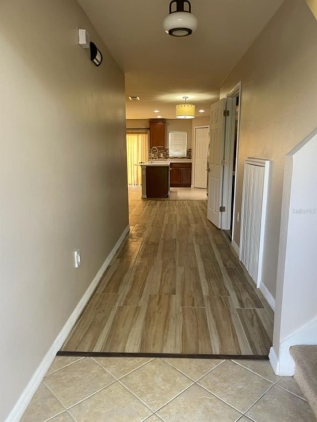2950 Willowleaf Ln, Wesley Chapel, FL 33544 - hallway with baseboards and light wood finished floors