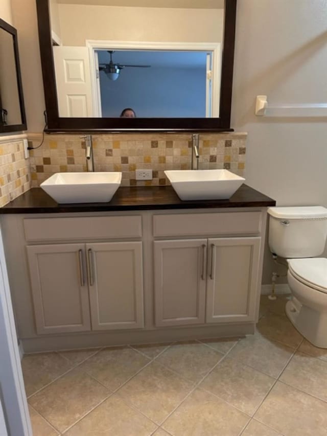 2950 Willowleaf Ln, Wesley Chapel, FL 33544 - bathroom with toilet, decorative backsplash, and a sink