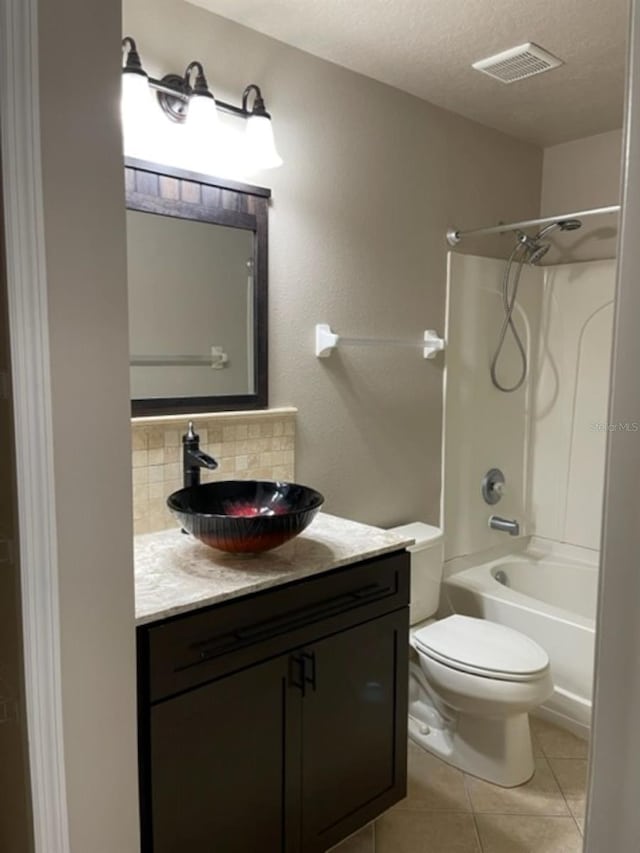 2950 Willowleaf Ln, Wesley Chapel, FL 33544 - full bathroom featuring visible vents, tasteful backsplash, tile patterned flooring, vanity, and toilet