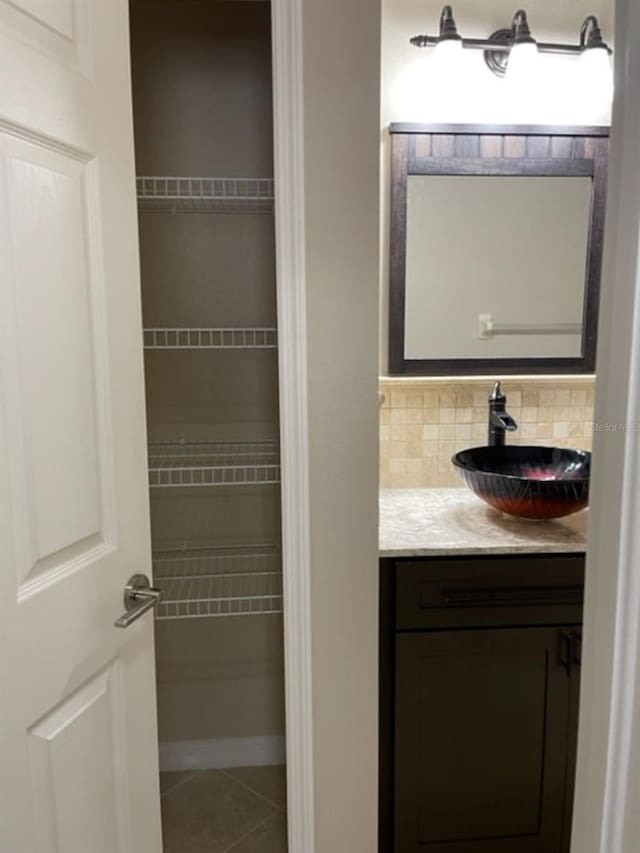 2950 Willowleaf Ln, Wesley Chapel, FL 33544 - bathroom with backsplash, tile patterned floors, and vanity