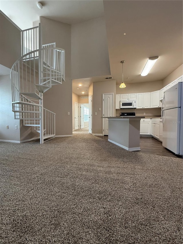 1530 Villa Capri Cir Unit 302, Odessa, FL 33556 - kitchen featuring dark countertops, white appliances, white cabinetry, open floor plan, and baseboards