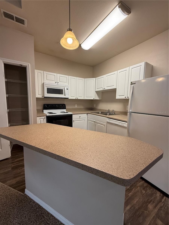 1530 Villa Capri Cir Unit 302, Odessa, FL 33556 - kitchen featuring visible vents, hanging light fixtures, a sink, white appliances, and white cabinetry