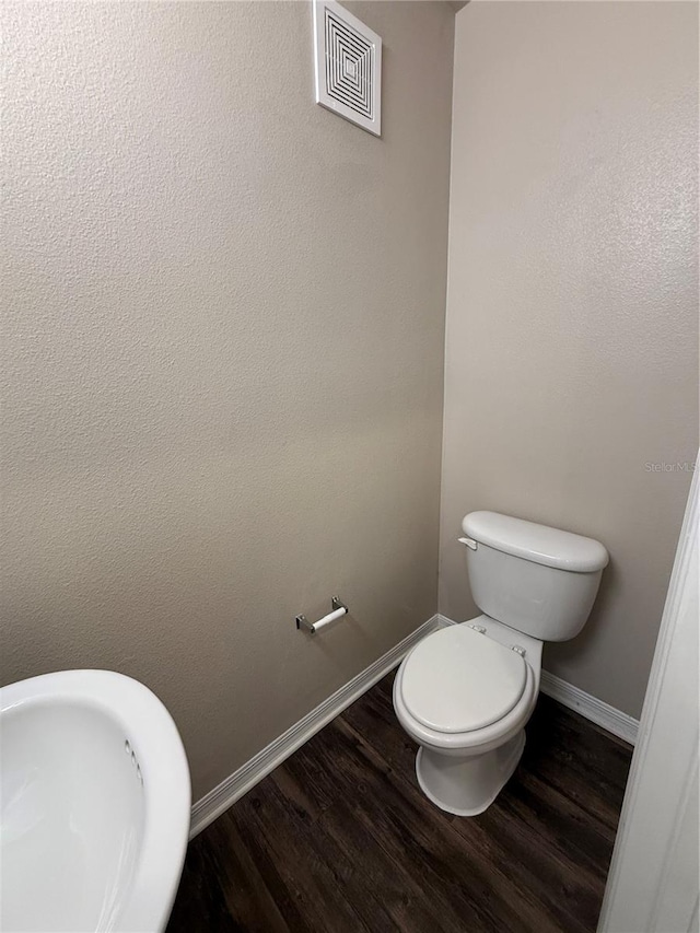 1530 Villa Capri Cir Unit 302, Odessa, FL 33556 - bathroom featuring visible vents, baseboards, wood finished floors, and toilet