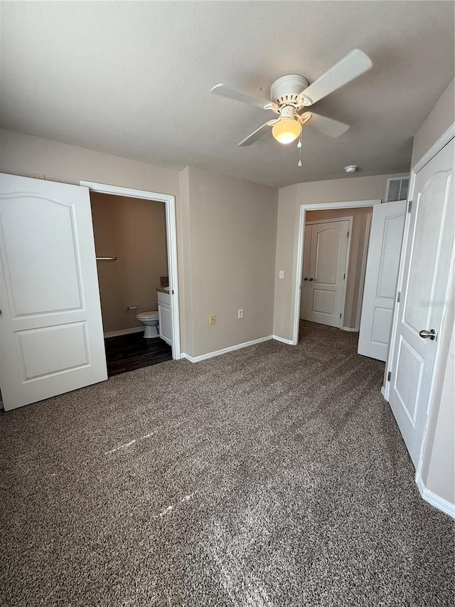 1530 Villa Capri Cir Unit 302, Odessa, FL 33556 - unfurnished bedroom featuring baseboards, visible vents, dark carpet, and connected bathroom