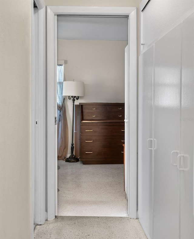 hallway featuring speckled floor
