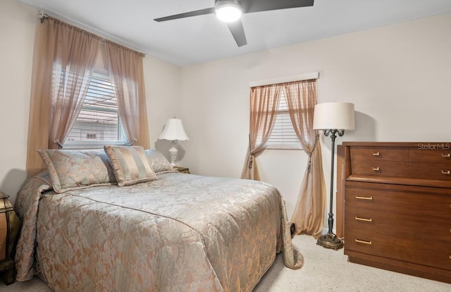 bedroom featuring multiple windows and ceiling fan