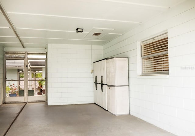 interior space with concrete block wall