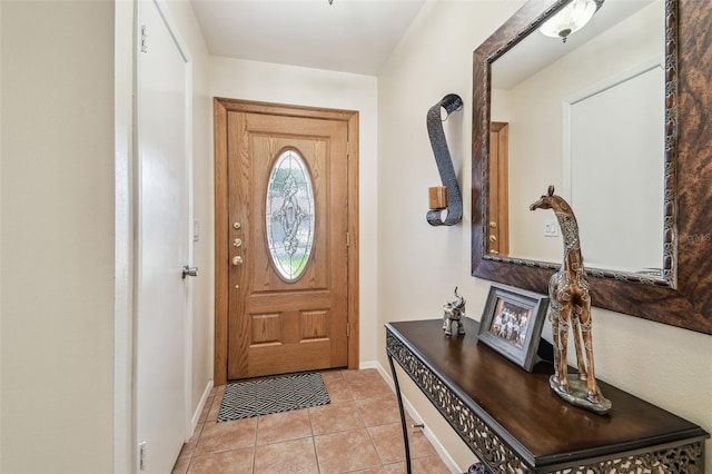 doorway featuring baseboards and light tile patterned floors