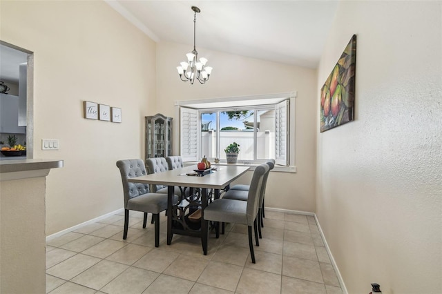 dining room featuring baseboards, light tile patterned flooring, lofted ceiling, and a notable chandelier