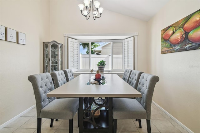dining room with an inviting chandelier, baseboards, light tile patterned floors, and vaulted ceiling
