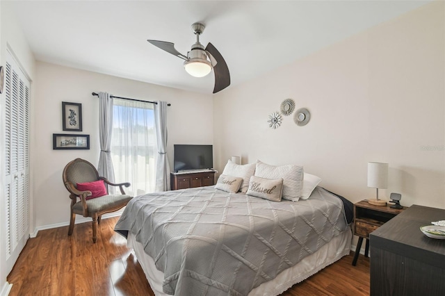 bedroom with baseboards, ceiling fan, a closet, and wood finished floors