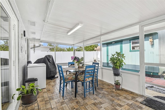 sunroom / solarium with visible vents, outdoor dining area, and a wealth of natural light