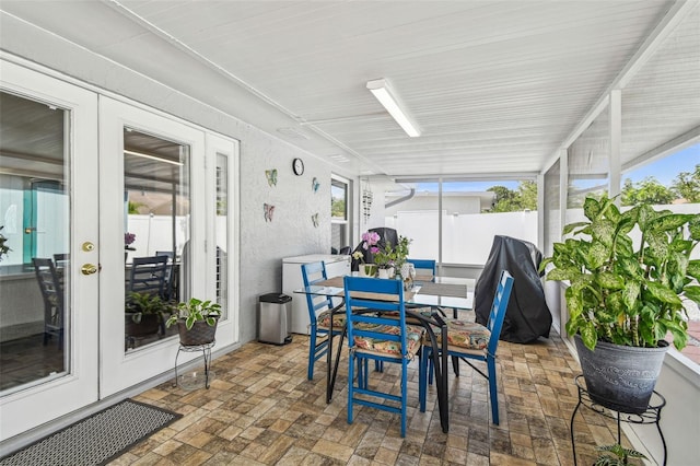 sunroom with outdoor dining area and french doors