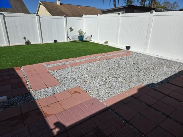 view of yard with a fenced backyard and a patio area