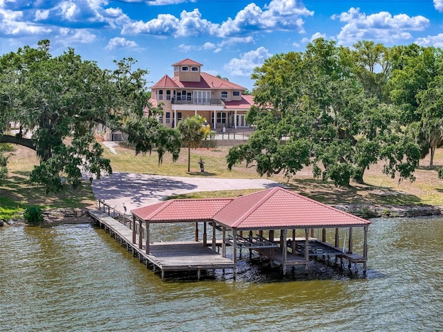 dock area with boat lift and a water view