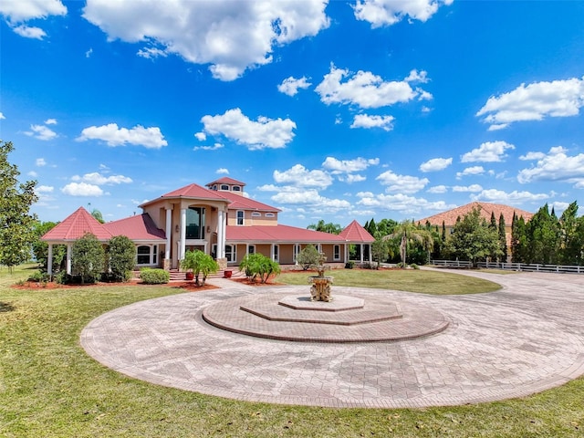 view of front of house with a front lawn, fence, and metal roof