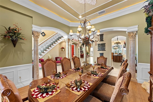 dining area with arched walkways, a chandelier, ornate columns, visible vents, and ornamental molding