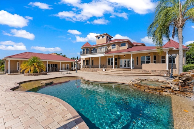 pool with a patio, a ceiling fan, an in ground hot tub, and french doors