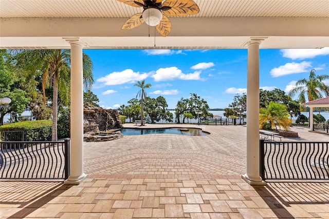 view of patio featuring ceiling fan and an outdoor pool