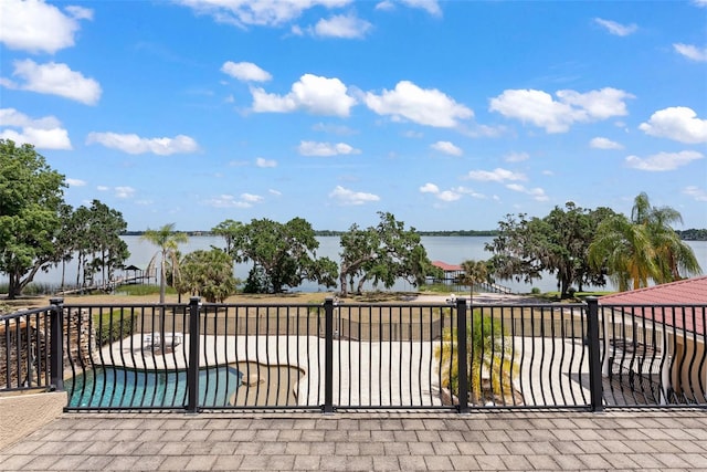 view of patio / terrace with a water view and a pool