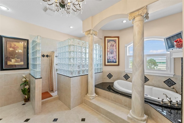 bathroom with a walk in shower, tile patterned flooring, decorative columns, and a garden tub