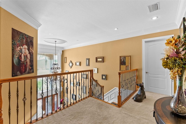 hallway with carpet flooring, recessed lighting, an upstairs landing, visible vents, and ornamental molding