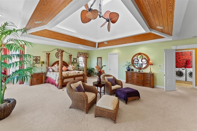carpeted bedroom featuring baseboards, washing machine and dryer, and lofted ceiling