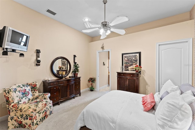 carpeted bedroom with baseboards, a ceiling fan, and visible vents