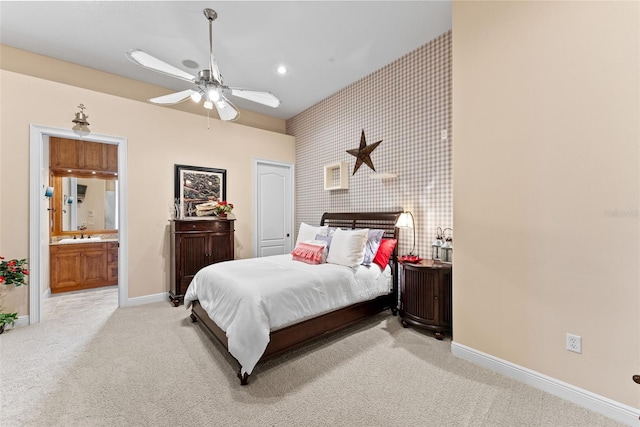 bedroom featuring light carpet, baseboards, wallpapered walls, recessed lighting, and a sink