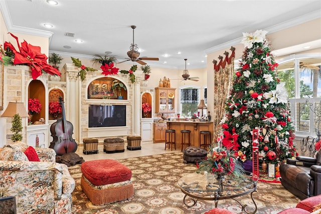 living room featuring a ceiling fan, visible vents, ornamental molding, and recessed lighting