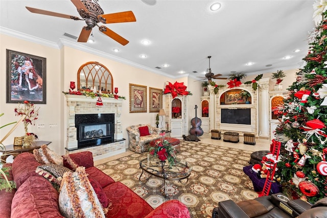 tiled living area featuring crown molding, visible vents, a glass covered fireplace, recessed lighting, and a ceiling fan