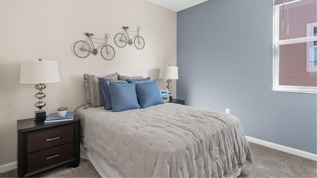bedroom featuring baseboards and carpet