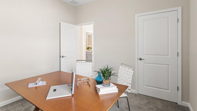 carpeted home office with baseboards and visible vents