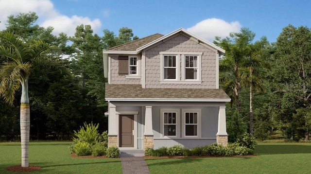 view of front of house with a shingled roof, stone siding, and a front yard