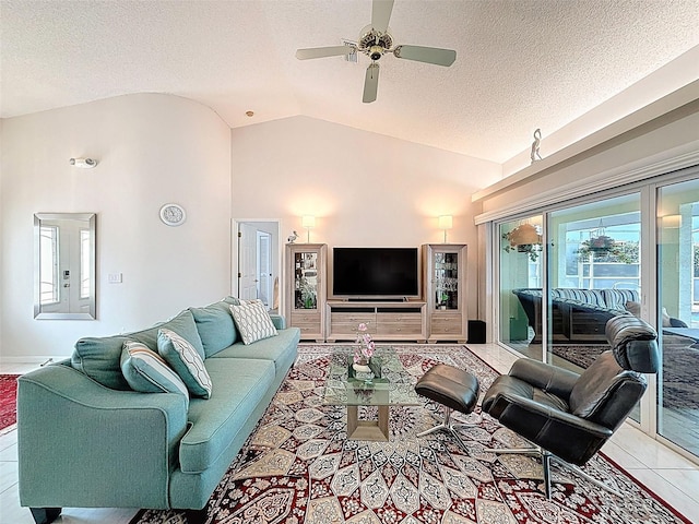 tiled living room featuring a textured ceiling, vaulted ceiling, and ceiling fan