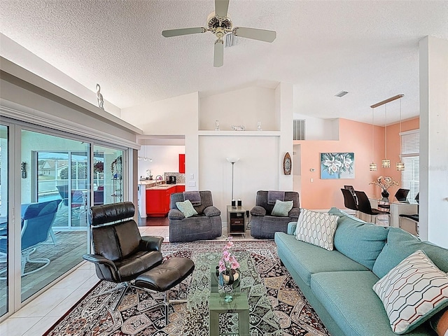 living area with a ceiling fan, a textured ceiling, and lofted ceiling