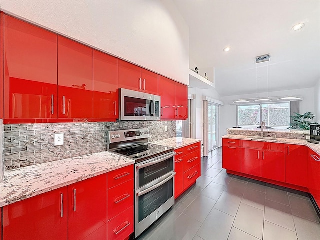 kitchen featuring a sink, red cabinetry, and appliances with stainless steel finishes