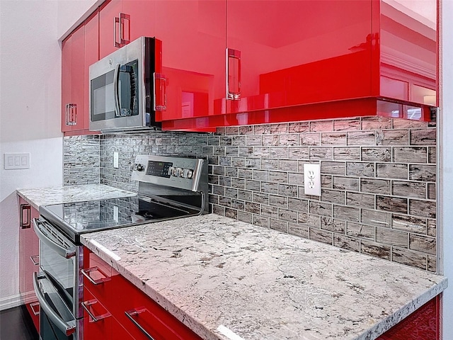 kitchen with stainless steel appliances and tasteful backsplash
