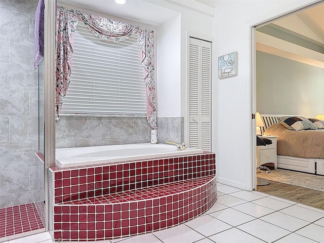 full bath featuring tile patterned floors, a closet, a tile shower, and a bath