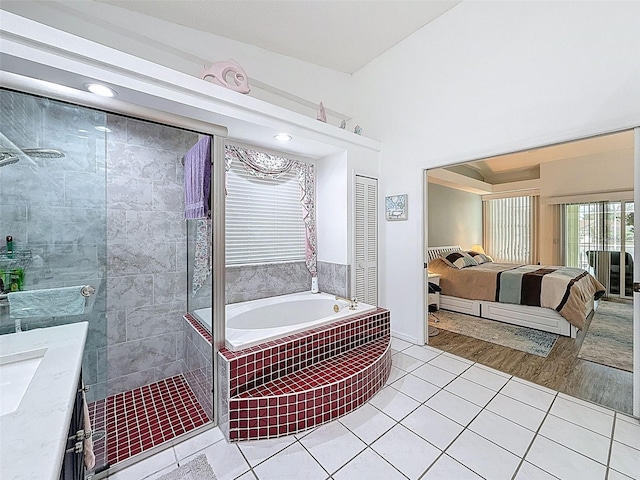 full bathroom with a walk in shower, a bath, tile patterned flooring, ensuite bath, and vanity