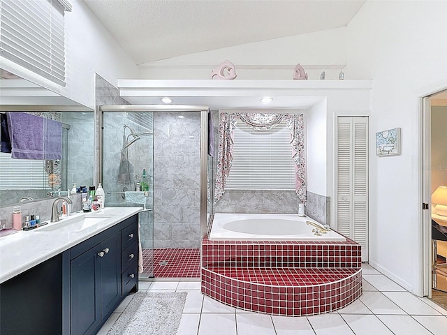 bathroom featuring a shower stall, tile patterned floors, a garden tub, and vaulted ceiling