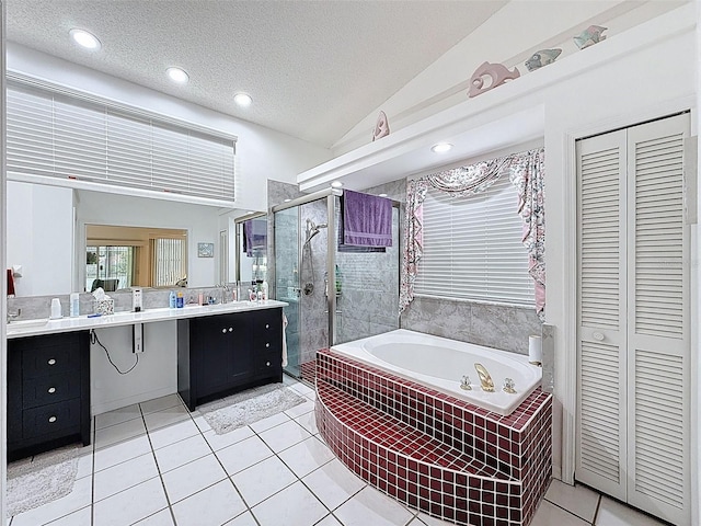 full bathroom featuring a closet, a bath, a shower stall, tile patterned flooring, and vanity