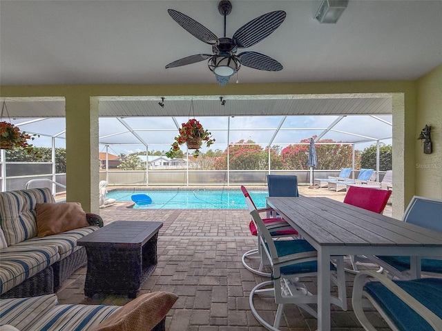 view of pool featuring ceiling fan, a patio area, a lanai, and a fenced in pool