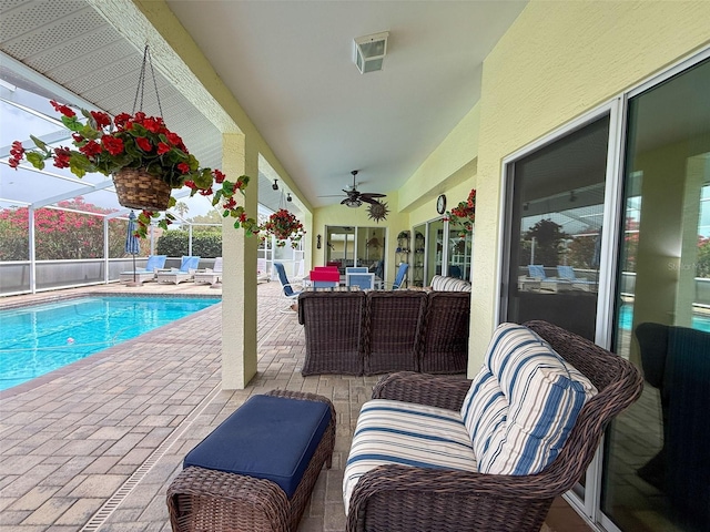 view of swimming pool with ceiling fan, a patio area, an outdoor living space, and a fenced in pool