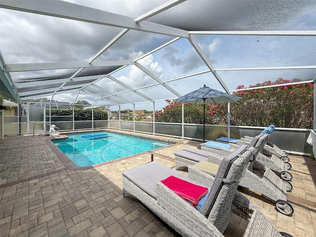 pool featuring a patio area and glass enclosure