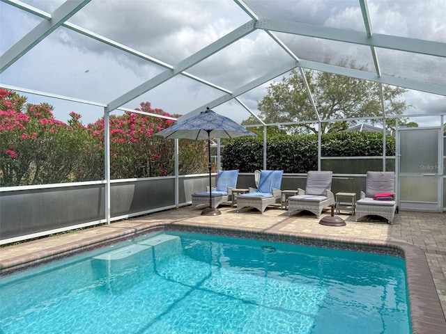 view of pool with a patio area, a fenced in pool, and a lanai