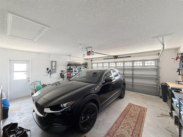 garage with electric panel and a garage door opener