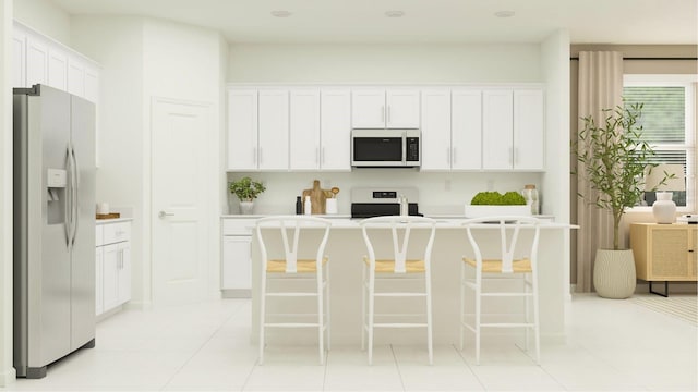 kitchen featuring white cabinets, stainless steel fridge with ice dispenser, a breakfast bar area, light countertops, and stove