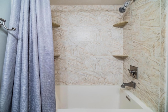 bathroom with shower / bath combo with shower curtain