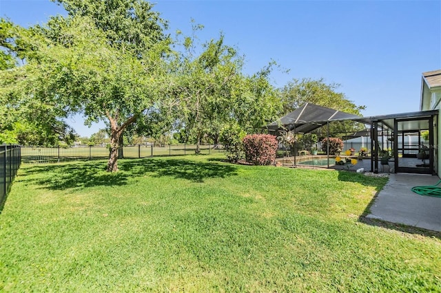 view of yard featuring a fenced backyard, a fenced in pool, a lanai, and a patio